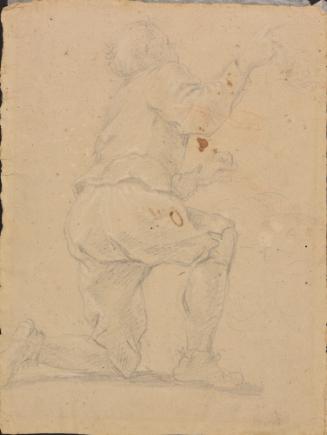A kneeling male figure seen from the rear