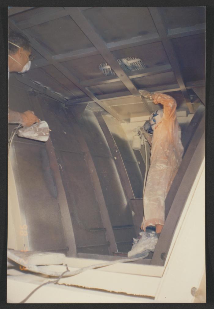 Yacht "Atlantide" at Manoel Island Yacht Yard (Malta) -  Aft peak compartment being sprayed by Libreri assisted by the late Buhu.