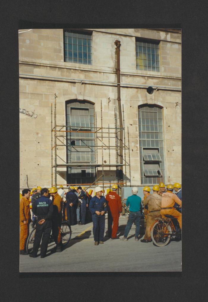 Unidentified gathering outside machine shop