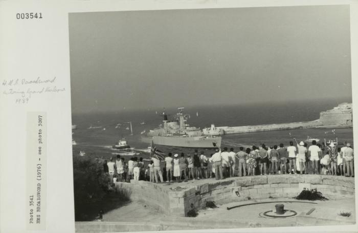 Crowds gathered at Fort St. Elmo to see "HMS BROADSWORD" (1976) leave the Grand Harbour