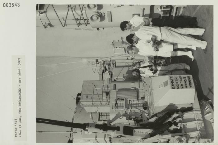 Men in awe of a 4 Omm AA gun onboard "HMS BROADSWORD" (1976)