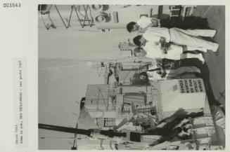 Men in awe of a 4 Omm AA gun onboard "HMS BROADSWORD" (1976)
