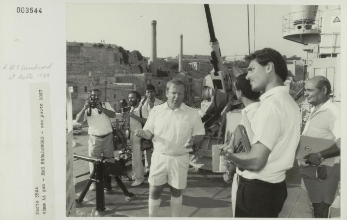 Crew member onboard "HMS BROADSWORD" (1976) showcasing a 4 Omm AA gun