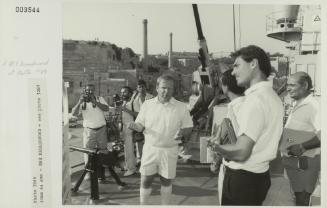 Crew member onboard "HMS BROADSWORD" (1976) showcasing a 4 Omm AA gun