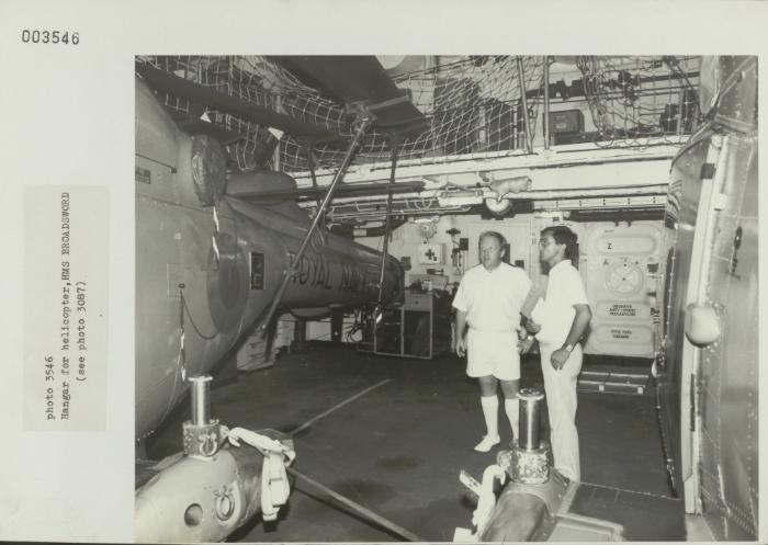 Crew member onboard "HMS BROADSWORD" (1976) showcasing the ship's helicopter hangar