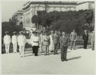 HE the President of Malta Dr. Censu Tabone and attendees standing at the foot of the War Memorial monument in Floriana Malta
