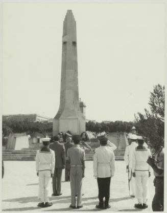 HE the President of Malta Dr. Censu Tabone and attendees standing at the foot of the War Memorial monument in Floriana Malta