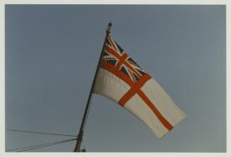 The British Royal Navy white ensign flag hoisted on the British Royal Yacht "BRITANNIA" (1953) while docked in the Grand Harbour (1997)