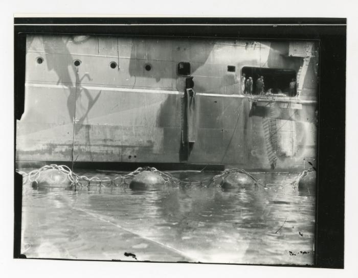 A group of workers standing at a gangway door while onboard