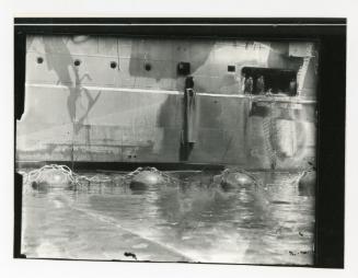 A group of workers standing at a gangway door while onboard