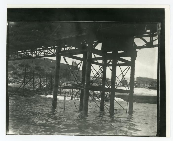 Metal piles rising out of the water forming the supports of Kalafrana pier