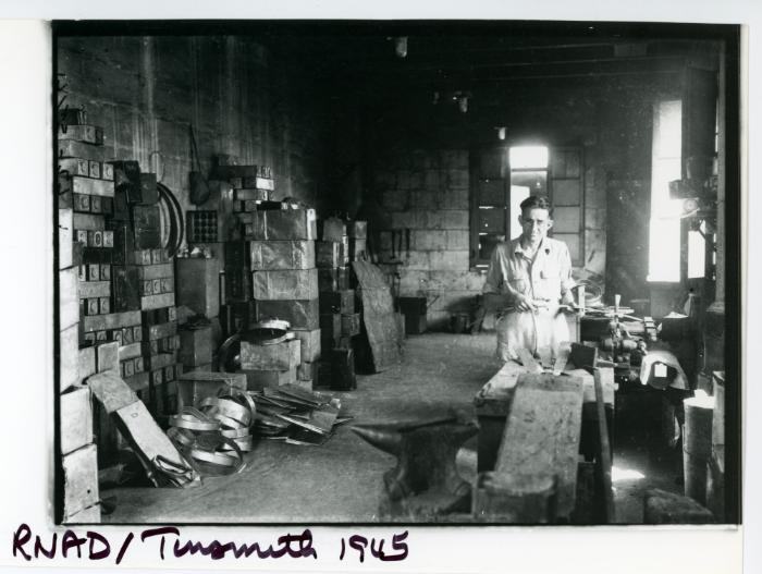 A tinsmith working in a R.N.A.D. (Royal Naval Armaments Depot) workshop