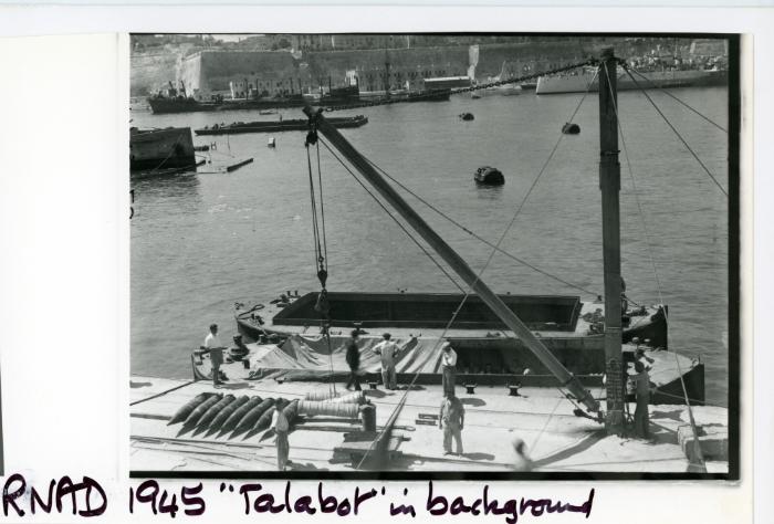 Work at a R.N.A.D. (Royal Naval Armaments Depot) with "TALABOT" in the background