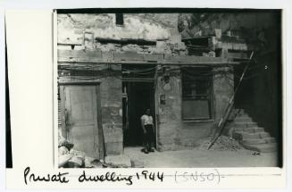 A young women standing on the threshold of a private dwelling