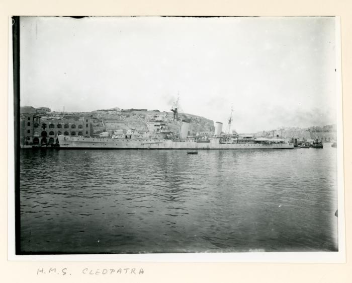 "HMS CLEOPATRA" docked in Parlatorio Wharf with the Dockyard E.V.T. Centre in the background