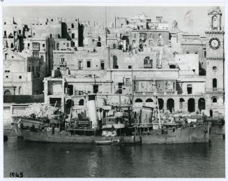 A trawler docked in Dockyard Creek in front of the Royal Naval Bakery, today the Malta Maritime Museum