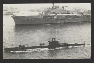 British S-class submarine HMS Sentinel (P256) with Audacious-class aircraft carrier HMS Eagle (R05) in the background, pre-refit and with a Westland Whirlwind helicopter aboard, at Grand Harbour, Malta
