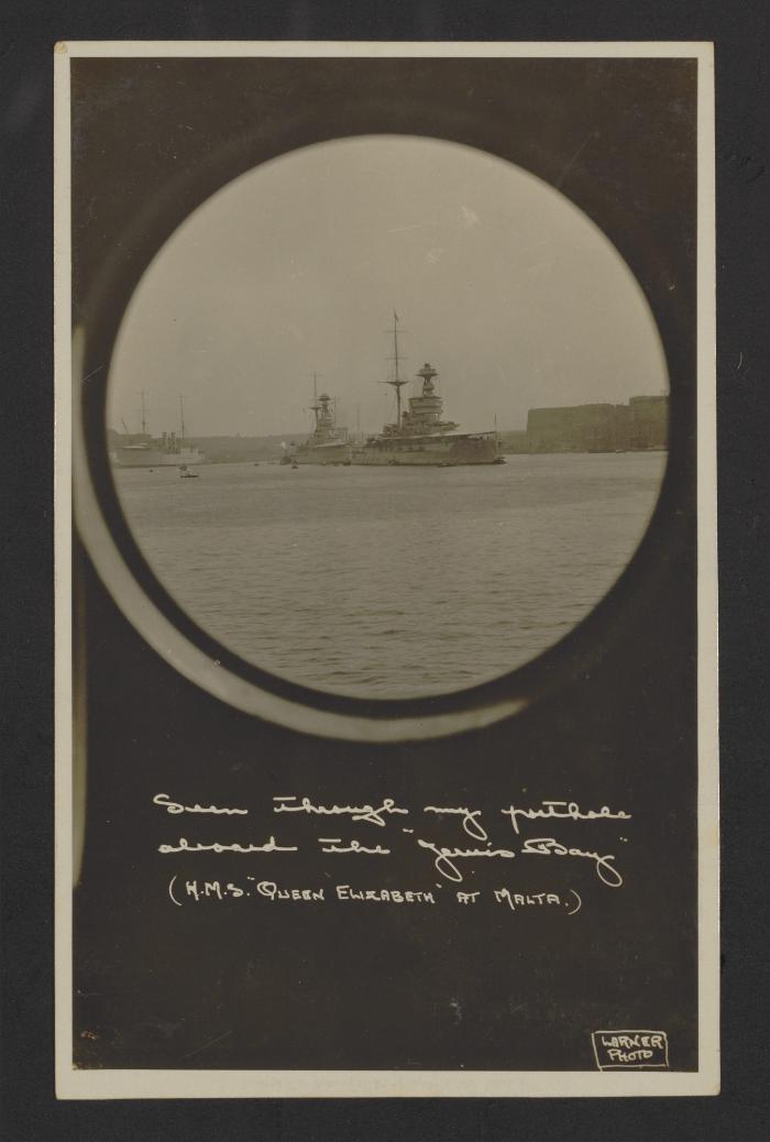 British Queen Elizabeth-class battleship HMS Queen Elizabeth (00), as seen from a porthole on armed merchant cruiser HMS Jervis Bay (F40), at Grand Harbour, Malta.