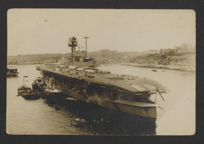 British aircraft carrier HMS Eagle (94), with Blackburn Dart torpedo bombers onboard, at Grand Harbour, Malta. Verso reads, "Dear Ted, Wishing you a Merry Xmas & a Happy New Year from your brother Ernie"