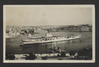 A British Colossus-class light aircraft carrier at Grand Harbour, Malta