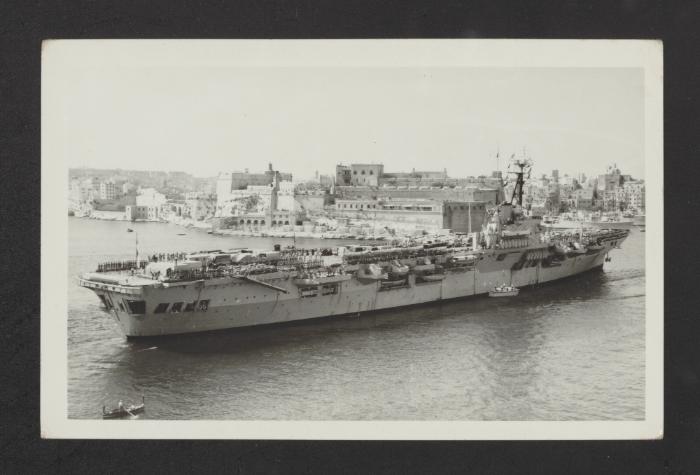 British Colossus-class aircraft carrier HMS Ocean (R68), carrying troops and motor transport prior to the Suez attack, at Grand Harbour, Malta