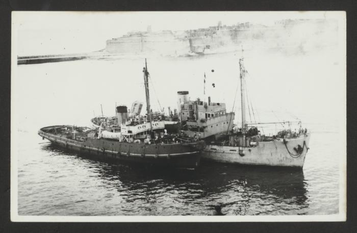 HMS Salvigil adjacent to a harbour tug