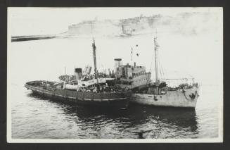 HMS Salvigil adjacent to a harbour tug