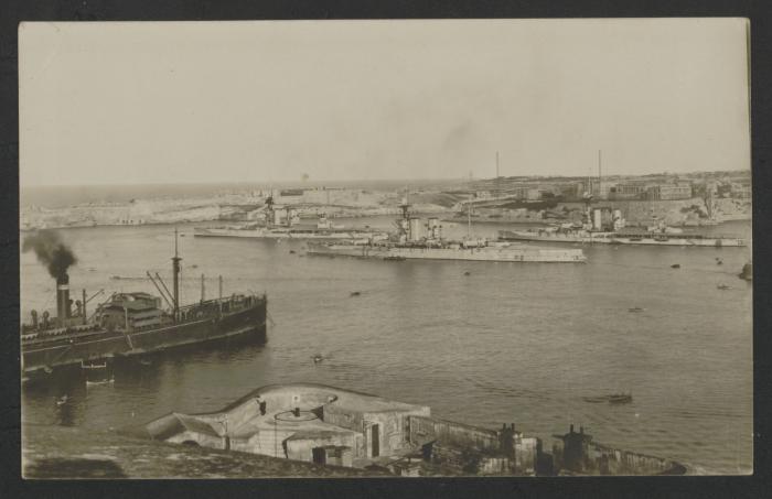 One (Queen Elizabeth-class?) and two (Iron Duke-class?) battleships next to Bighi Naval Hospital, with merchant vessel and a view of Fort Lascaris in the foreground. Picture taken from the Saluting Battery.