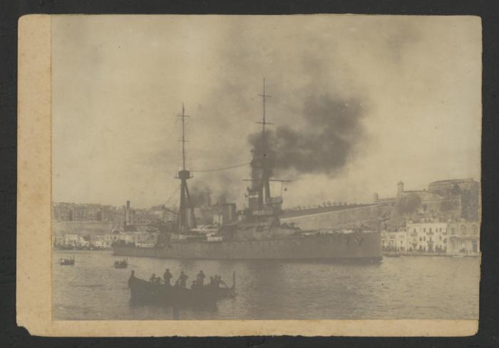 (Heavy Cruiser?) in Grand Harbour, Malta, with Floriana in the background