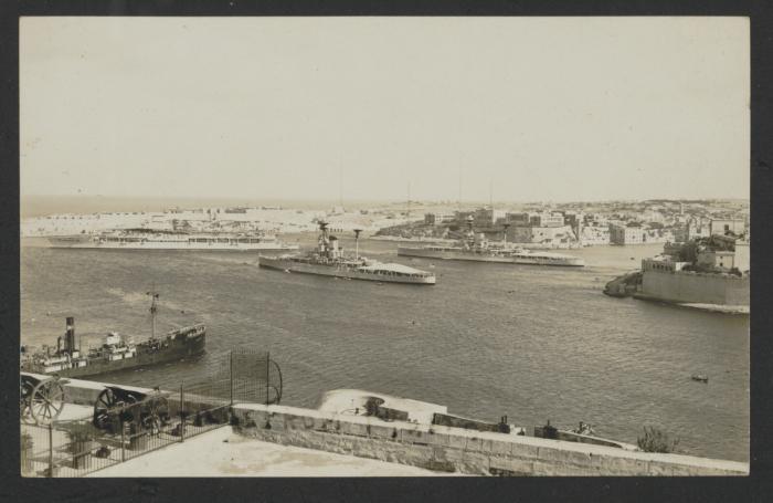 Two (Dreadnought?) battleships and one Courageous-class aircraft carrier in Grand Harbour, Malta, with the Saluting Battery and Fort Lascaris in the foreground.