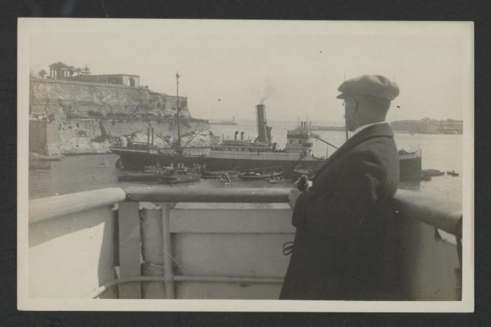 View of a mercant vessel for a neighbouring craft at Grand Harbour, Malta, surrounded by bumboats and other craft